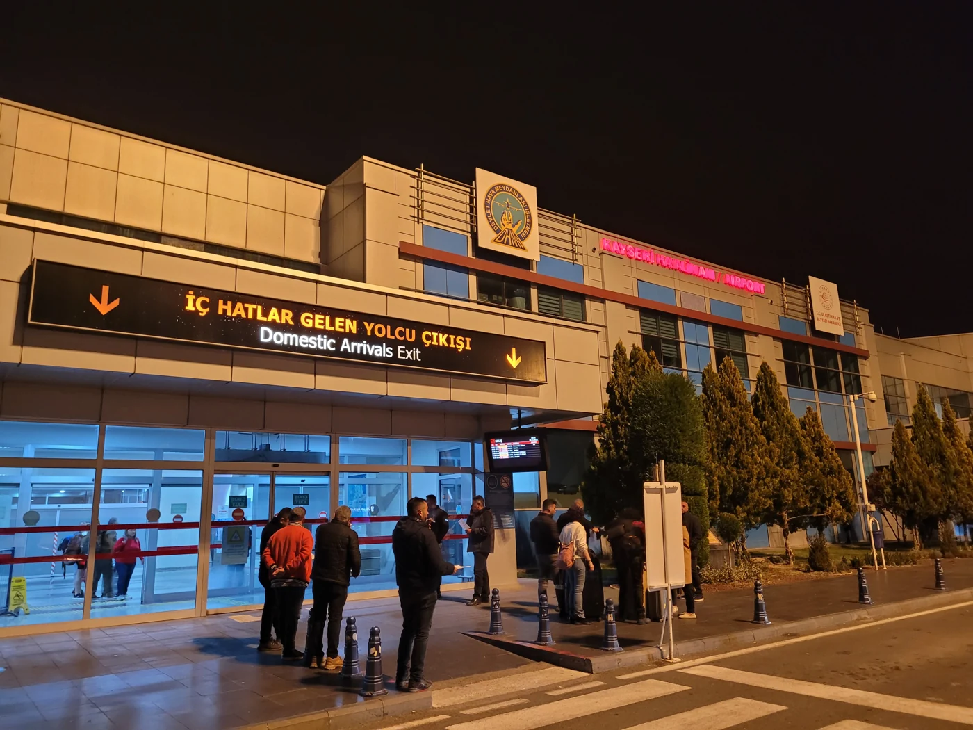 Kayseri Airport’s illuminated domestic arrivals exit at night.